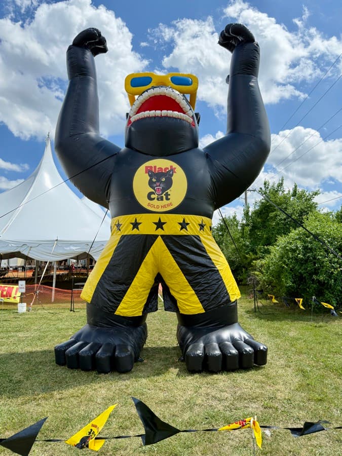 Joerilla — Crazy Joe's giant inflatable Black Cat gorilla mascot — fists raised in front of the white fireworks tents at 171st and Holmes in Kansas City